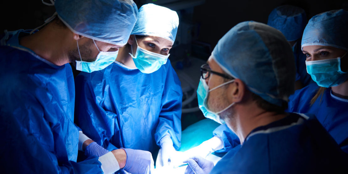 team-of-surgeons-in-the-dark-operating-room-GQTEH5K-1110×624-1 (1)